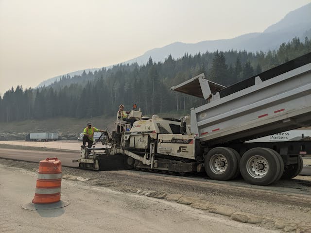 Asphalt paving crew working a road surface