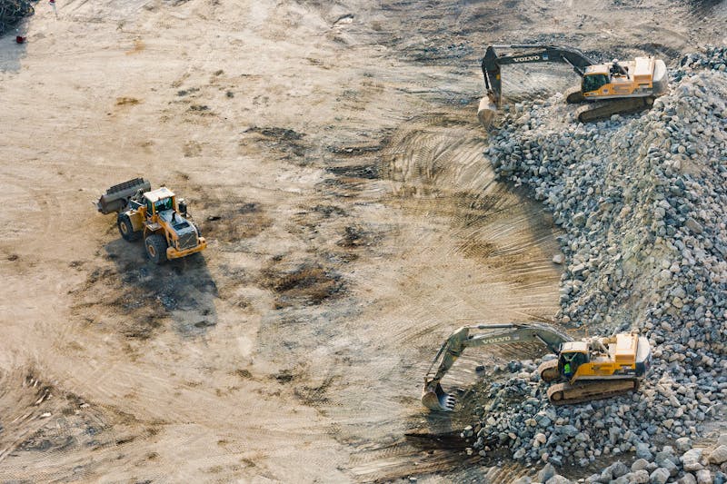 Excavators and a loader working a bulk earthworks site