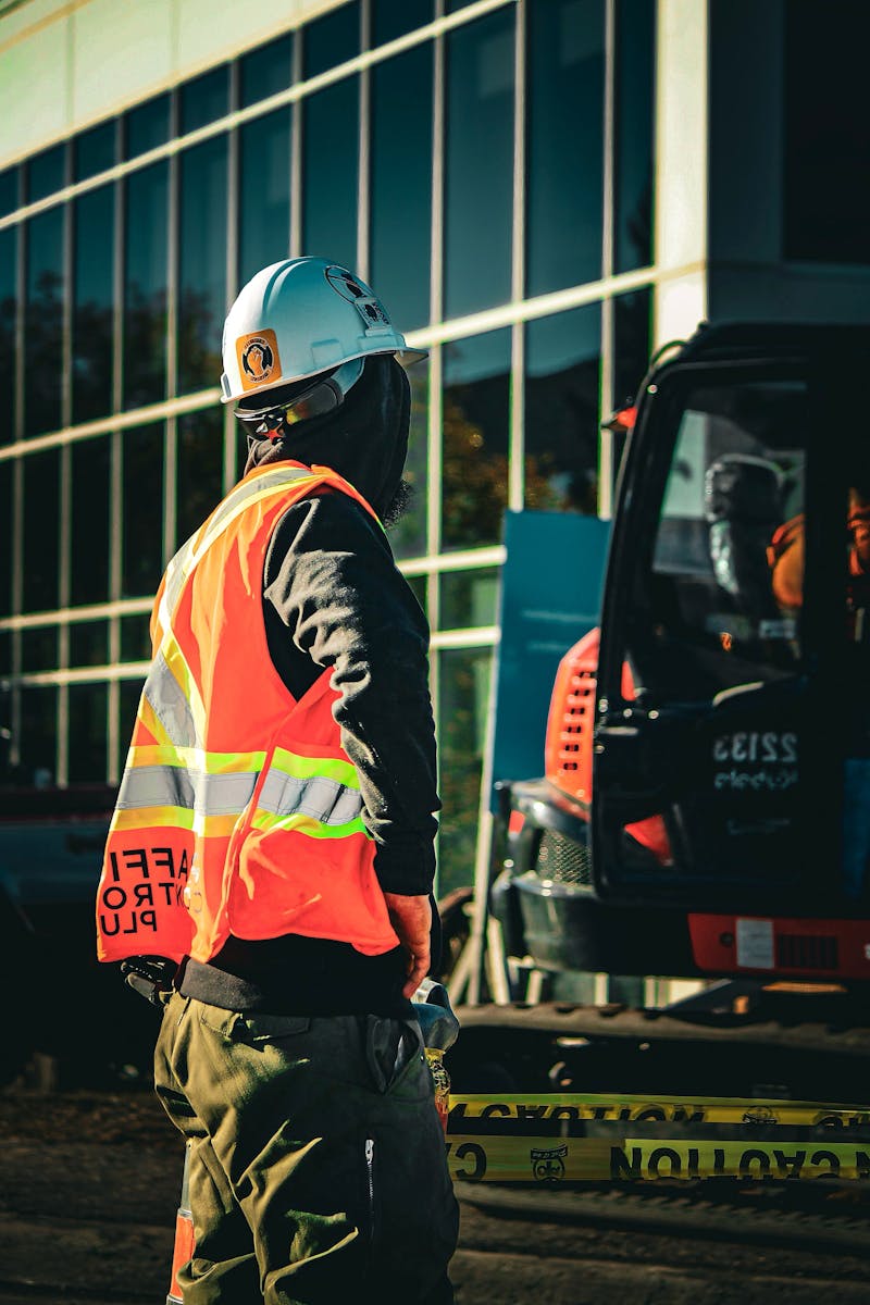 Traffic controller holding a stop sign on a Melbourne road in a hi vis vest